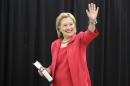 Former Secretary of State Hillary Clinton waves as she arrives at a Little Rock, Ark., Wal-Mart store for a book signing event Friday, June 27, 2014. She carries a copy of her book "Hard Choices".(AP Photo/Danny Johnston)