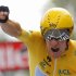 Sky Procycling rider and leader's yellow jersey Wiggins of Britain holds up his arm as he crosses the finish line during the individual time trial of the 19th stage of the 99th Tour de France cycling race between Bonneval and Chartres