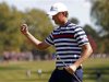 U.S. golfer Simpson celebrates sinking a birdie putt to win the 10th hole during the 39th Ryder Cup singles golf matches at the Medinah Country Club