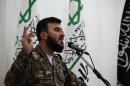 Zahran Alloush, commander of Jaish al-Islam (Army of Islam) Syrian opposition faction, pictured during a press conference in the rebel-held Damascus suburb of Eastern Ghouta on June 25, 2014
