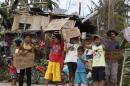 Children hold signs asking for help and food along the highway, after Typhoon Haiyan hit Tabogon town