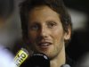 Lotus F1 Formula One driver Romain Grosjean of France speaks to journalists in the paddock ahead of the Singapore F1 Grand Prix