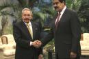 Cuba's President Raul Castro, left, shakes hands with Venezuela's President Nicolas Maduro, before the ALBA summit at Revolution Palace in Havana, Sunday, Dec 14, 2014. The left-leaning regional economic and diplomatic bloc known as ALBA marked its 10th anniversary Sunday amid pressures by tumbling oil prices on petroleum-producing countries such as top ALBA member Venezuela. (AP Photo/Ismael Francisco, Cubadebate)