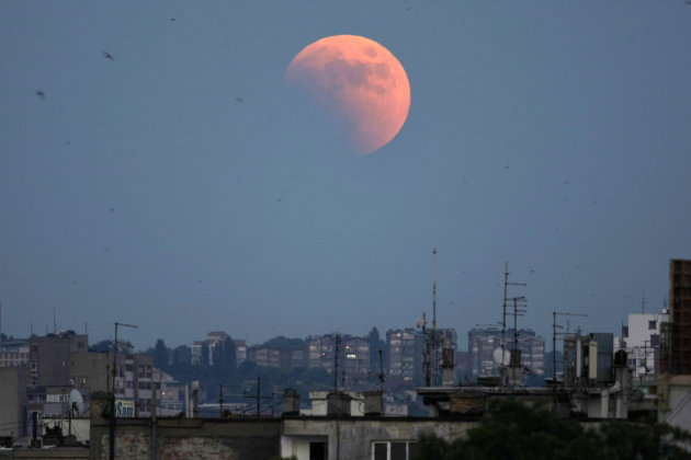 A partially eclipsed moon rises on the sky over Belgrade, Serbia, Wednesday, June 15, 2011. The total lunar eclipse was visible throughout most parts of Europe on Wednesday evening. (AP Photo/ Marko D