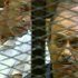 This video image taken from Egyptian State Television shows former Egyptian Interior Minister Habib el-Adly, right, in a cage of mesh and iron bars during his trial in a Cairo courtroom Thursday Aug. 4, 2011. The trial of Hosni Mubarak's security chief Habib el-Adly and six top police officers charged with ordering the use of deadly force against protesters during this year's uprising in Egypt has resumed. Habib el-Adly, six senior police officers and ousted President Hosni Mubarak could be sentenced to death if convicted of ordering protesters killed during the uprising that toppled the longtime president on Feb. 11, 2011.   (AP Photo/Egyptian State TV)   EGYPT OUT