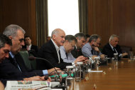 <p>               In this photo provided by Greece's Prime minister office, on Tuesday, Nov. 8, 2011, Greek Prime Minister George Papandreou, at table 3rd left, and Greek Finance minister Evangelos Venizelos, 4th left, attend an emergency  cabinet meeting at the parliament in Athens. Power-sharing talks between Greece's two main political parties entered their second day Tuesday, as European leaders stepped up the pressure for a quick resolution by holding back a vital rescue loan that the country needs to prevent a devastating bankruptcy. (AP Photo/Greek Prime Minister Office/Vasilis Filis, HO) EDITORIAL USE ONLY