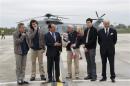 French President Hollande speaks with former French hostages and journalists moments after thier arrival by helicopter from Evreux to the military airbase in Villacoulbay
