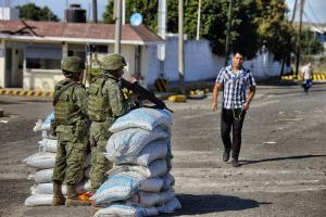 Mexican soldiers stand behind sandbags in a checkpoint &hellip;