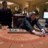 Baccarat dealer Ramiro Nepomuceno, right, shuffles cards as floor supervisor Sam Insyxiengmay looks on while preparing a table for play at the MGM Hotel and Casino, Wednesday, Jan. 25, 2012, in Las Vegas. There are generally more Asian gamblers in Vegas because of the Chinese New Year, and it means increased traffic at high limit baccarat tables. Though not widely known, baccarat is actually the most profitable table game for casinos which try to court Asian gamblers who tie luck and good fortune to the start of the Lunar Year. (AP Photo/Julie Jacobson)