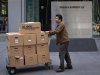 A man moves boxes out of the offices of Dewey & LeBoeuf in New York