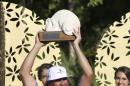 Pat Perez of the United States holds up his trophy after he won the OHL Classic at Mayakoba golf tournament in Playa del Carmen, Mexico, Sunday, Nov. 13, 2016. (AP Photo/Israel Leal)