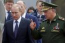 Russian President Putin listens to Defence Minister Shoigu as they arrive for opening of Army-2015 international military forum in Kubinka