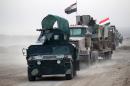 Shiite fighters drive their vehicles towards the village of Umm Sijan, south of Mosul, on October 31, 2016 during Iraqi forces' operation to recapture the main hub city from the Islamic State