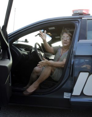 Miriam Valdes sits in a Hialeah, Fla., police patrol …