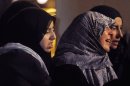 Women react outside of a Shi'ite mosque in Brussels on Tuesday, March 13, 2012. Local media late Monday evening reported that an arson attack took place at the mosque and that the local Imam died of suffocation in a room inside. (AP Photo/Geert Vanden Wijngaert)
