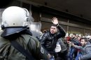 A protester clashes with riot policemen during a protest outside the Labour Ministry in Athens