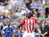 Stoke's Kenwyne Jones, bottom, fights for the ball against Chelsea's John Obi Mikel during their English Premier League soccer match at the Britannia Stadium, Stoke, England, Sunday Aug. 14, 2011. (AP Photo/Jon Super)   NO INTERNET/MOBILE USAGE WITHOUT FOOTBALL ASSOCIATION PREMIER LEAGUE(FAPL)LICENCE. EMAIL info@football-dataco.com FOR DETAILS.