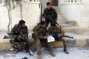 Syrian pro-government forces read a map in the town of Nabak near Damascus on December 7, 2013