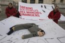 Members of the Front de Gauche political party hold a sheet a puppet with the likeness of France's President Sarkozy during a protest demonstration in Nice
