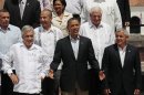 President Barack Obama, front center, gestures during the official photo at the sixth Summit of the Americas in Cartagena, Colombia, Sunday April 15, 2012. Obama is flanked by Presidents Sebastian Pinera of Chile, front left, and Otto Perez Molina of Guatemala, front right. Pictured behind the three leaders are Presidents Porfirio Lobo of Honduras, middle row, left, Felipe Calderon of Mexico, middle row, second from left, Ricardo Martinelli of Panama, middle row, right, and Trinidad and Tobago's Prime Minister Kamla Persad-Bissessar, third row, center. (AP Photo/Fernando Llano)