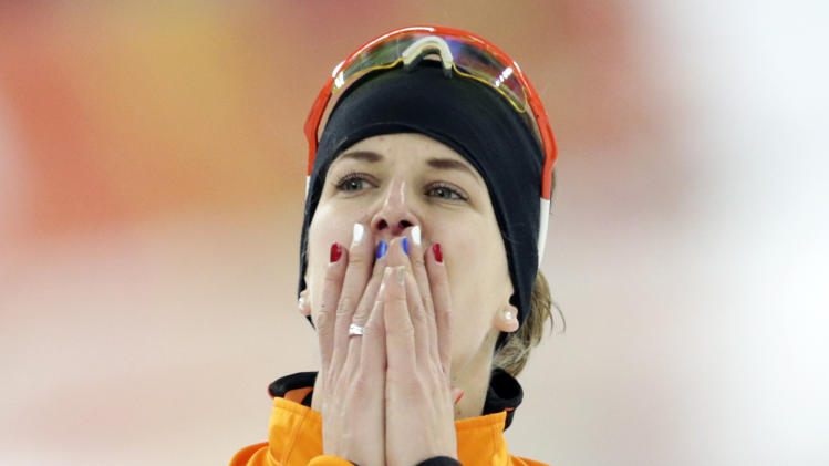 Ireen Wust of the Netherlands celebrates after winning gold in the women's 3,000-meter speedskating race at the Adler Arena Skating Center during the 2014 Winter Olympics, Sunday, Feb. 9, 2014, in Sochi, Russia. (AP Photo/Matt Dunham)