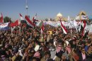 Iraqi Sunni Muslims wave national flags and chant slogans during an anti-government demonstration in Tikrit