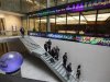 People walk down a stairway inside the London Stock Exchange Atrium in London