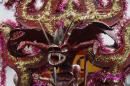 A man with a devil's mask dances in La Diablada in Pillaro, Ecuador, Monday, Jan. 6, 2014, to celebrate the end of the year and the start of the new one. The town of Pillaro kicks off the feast of La Diablada with neighborhoods competing to bring in as many people as possible dressed as different characters. Originally the devil costume was used to open up space to allow other participants to dance, but over the years the character gained popularity and became the soul of the feast. (AP Photo/Dolores Ochoa)