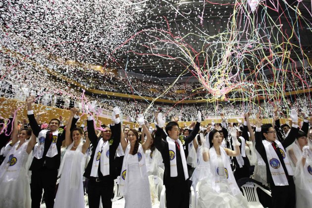 Newlyweds celebrate during a mass wedding ceremony of the Unification Church at Cheongshim Peace World Centre in Gapyeong