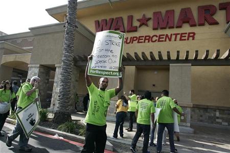 Striking Walmart workers walk a picket line during a protest over unsafe working conditions and poor wages outside a Walmart store in Pico Rivera, California, October 4, 2012. REUTERS/Jonathan Alcorn