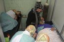 People injured in what the government said was a chemical weapons attack, breathe through oxygen masks as they are treated at a hospital in the Syrian city of Aleppo