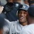 New York Yankees' Robinson Cano smiles as he celebrates with teammates after hitting a three-run home run during the first inning of a baseball game against the Chicago White Sox in Chicago, Wednesday, Aug. 3, 2011. (AP Photo/Nam Y. Huh)