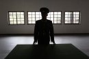 A North Korean military officer talks the history at a museum hall at Demilitarized Zone that separates the two Koreas in Panmunjom, North Korea Monday, April 23, 2012. North Korea promised Monday to reduce South Korea's conservative government 