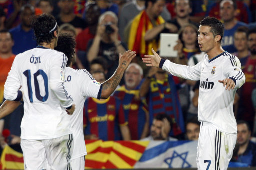 Real Madrid's Ronaldo celebrates with Ozil and Marcelo after scoring his second goal against Barcelona during their Spanish first division soccer match at Nou Camp stadium in Barcelona