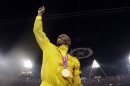 Jamaica's Usain Bolt reacts after receiving a gold medal for the men's 4x100-meter during the athletics in the Olympic Stadium at the 2012 Summer Olympics, London, Saturday, Aug. 11, 2012. (AP Photo/Matt Slocum)