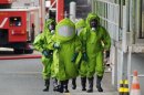 Firemen in protective clothes walk over the grounds of food company Kraft Foods in Bad Fallingbostel