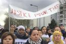 People march in the streets of Aulnay-sous-Bois, north of Paris, France, holding a sign reading "Justice for Theo" during a protest, a day after a French police officer was charged with the rape of a youth, Monday, Feb. 6, 2017. One French police officer has been charged with raping a 22-year-old man and three others have been charged with assault after an identity check degenerated last week in the Paris suburb of Aulnay-sous-Bois. (AP Photo/Milos Krivokapic)