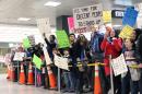 Protesters demonstrate against US President Donald Trump's travel ban at Washington's Dulles International Airport on January 29, 2017, in Sterling, Virginia
