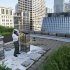 In this photo taken Tuesday, July 12, 2011, beekeeper Michael Thompson, applies smoke, to settle down the more than 1000,000 bees in a hive on top of City Hall in Chicago. (AP Photo/Charles Rex Arbogast)