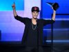 FILE - In this Nov. 18, 2012 file photo, Justin Bieber accepts the award for favorite album - pop/rock for "Believe" at the 40th Anniversary American Music Awards, in Los Angeles. The Los Angeles City Attorney's Office appealed on Wednesday Dec. 12, 2012, a criminal court judge's ruling tossing anti-paparazzi counts against a photographer charged with driving recklessly in pursuit of Bieber. (Photo by John Shearer/Invision/AP, File)