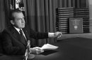 FILE - In this April 29, 1974, file photo, President Richard M. Nixon points to the transcripts of the White House tapes after he announced during a nationally-televised speech that he would turn over the transcripts to House impeachment investigators, in Washington. The last 340 hours of tapes from Nixon's White House were released Wednesday, Aug. 21, 2013, along with more than 140,000 pages of text materials. (AP Photo/File)