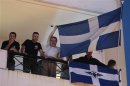 Supporters of Greece's extreme right Golden Dawn party hold flags from their party's headquarters in Athens