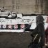 In this Monday, Jan. 23, 2012 photo, Egyptian women walk past graffiti depicting a military tank on a wall under a bridge in Cairo, Egypt. In May, Mohamed Fahmy, known in the graffiti world as Gazneer, made one of Cairo's largest and longest surviving pieces of street art under a bridge used by taxi drivers to urinate. It was an image of a military tank pointed toward a boy on a bike who, rather than carrying a traditional bread delivery, was carrying the city on his head. It was a symbolic reference to youth who care for the nation and are heading toward a collision with Egypt's military rulers. On his blog, Ganzeer wrote: "Our only hope right now is to destroy the military council using the weapon of art." (AP Photo/Nariman El-Mofty)