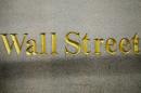 FILE - This Oct. 8, 2014 file photo shows a Wall Street address in the side of a building in New York. U.S. stocks are opening lower Tuesday, March 10, 2015, reversing a gain from the day before, following declines in European markets. (AP Photo/Mark Lennihan, File)