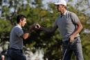 Europe's Thomas Pieters and Europe's Rory McIlroy celebrate a birdie on the 14th hole during a four-ball match at the Ryder Cup golf tournament Saturday, Oct. 1, 2016, at Hazeltine National Golf Club in Chaska, Minn. (AP Photo/David J. Phillip)