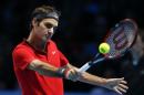 Switzerland's Roger Federer plays a return to Canada's Milos Raonic during their ATP World Tour Finals tennis match at the O2 Arena in London, Sunday, Nov. 9, 2014. (AP Photo/Alastair Grant)
