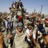 Libyan fighters chants slogans as they take control of Moammar Gadhafi loyalists' villages in the desert some 750 km south of Tripoli, at Gohta, north of the southern city of Sebbah, Libya, Sunday, Sept. 18, 2011. (AP Photo/Francois Mori)