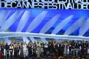 French director Jacques Audiard (C) poses on stage with Feature Film jury members after being awarded with the Palme d'Or for his film "Dheepan" during the closing ceremony of the 68th Cannes Film Festival in Cannes, France, on May 24, 2015
