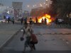Protesters are seen on a street after setting fire to garbage containers during clashes with riot police in Budaiya, west of Manama