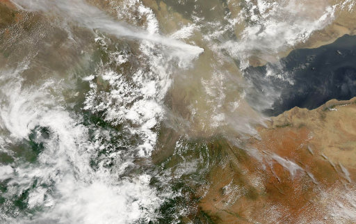 In this photo made available by NASA, a plume of smoke from an erupting volcano in southern Eritrea, seen at top center, is carried by winds blowing across northern Ethiopia, Monday, June 13, 2011. Airlines that travel through East Africa are keeping an eye on ash cloud after a volcano eruption in the tiny country of Eritrea. (AP Photo/NASA/GSFC, MODIS RAPID RESPONSE) MANDATORY CREDIT